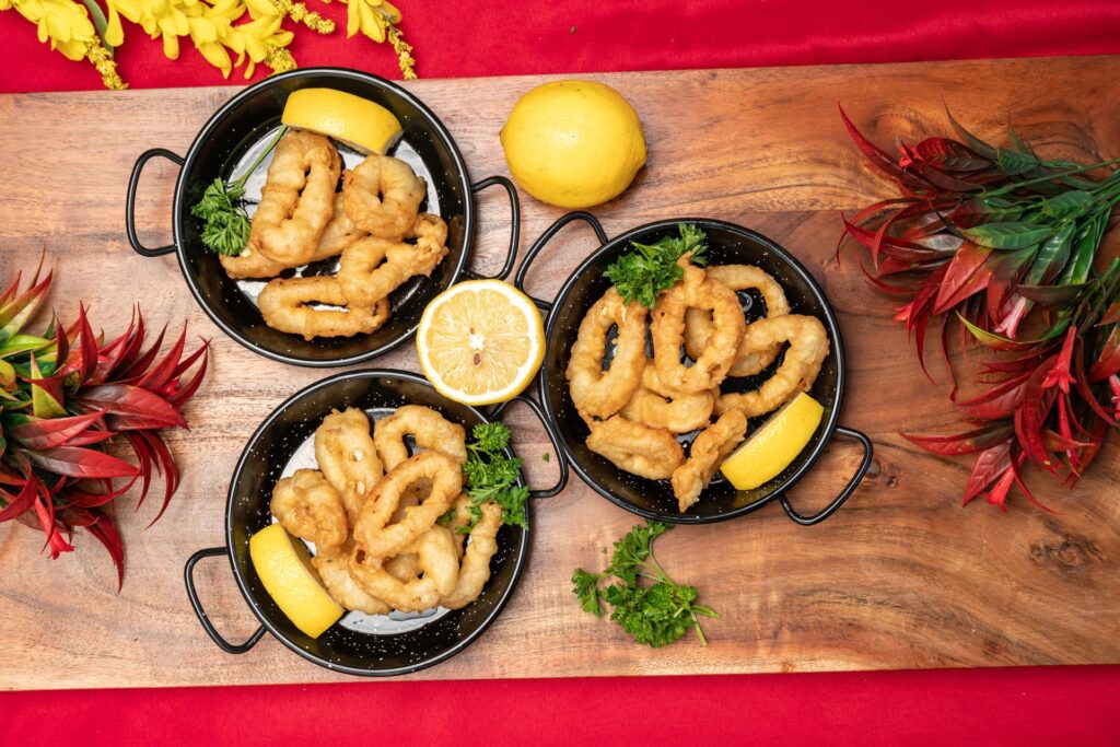 Overhead view of calamares a la romana on a wooden board