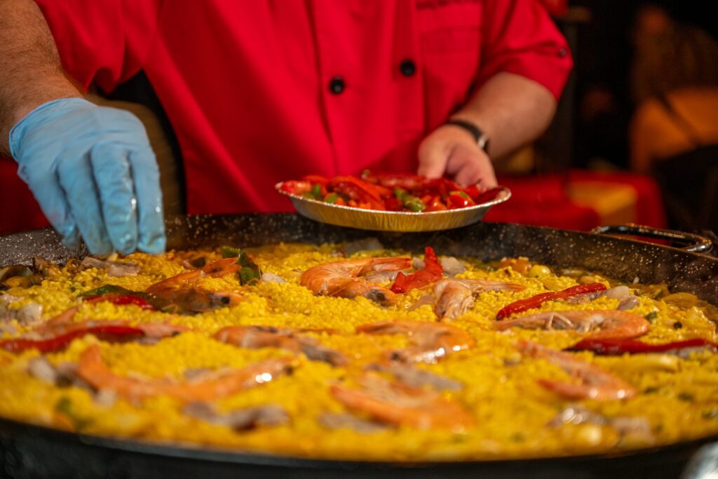 Chef Nino finishing a seafood paella with roasted peppers