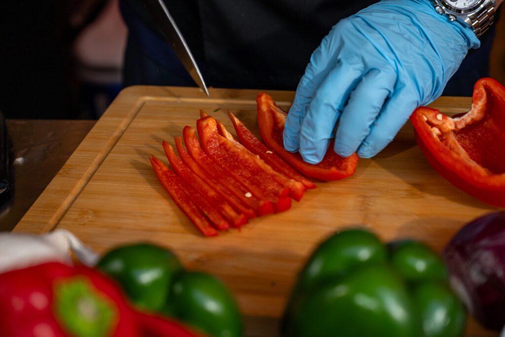 Slicing red bell peppers for the sofrito