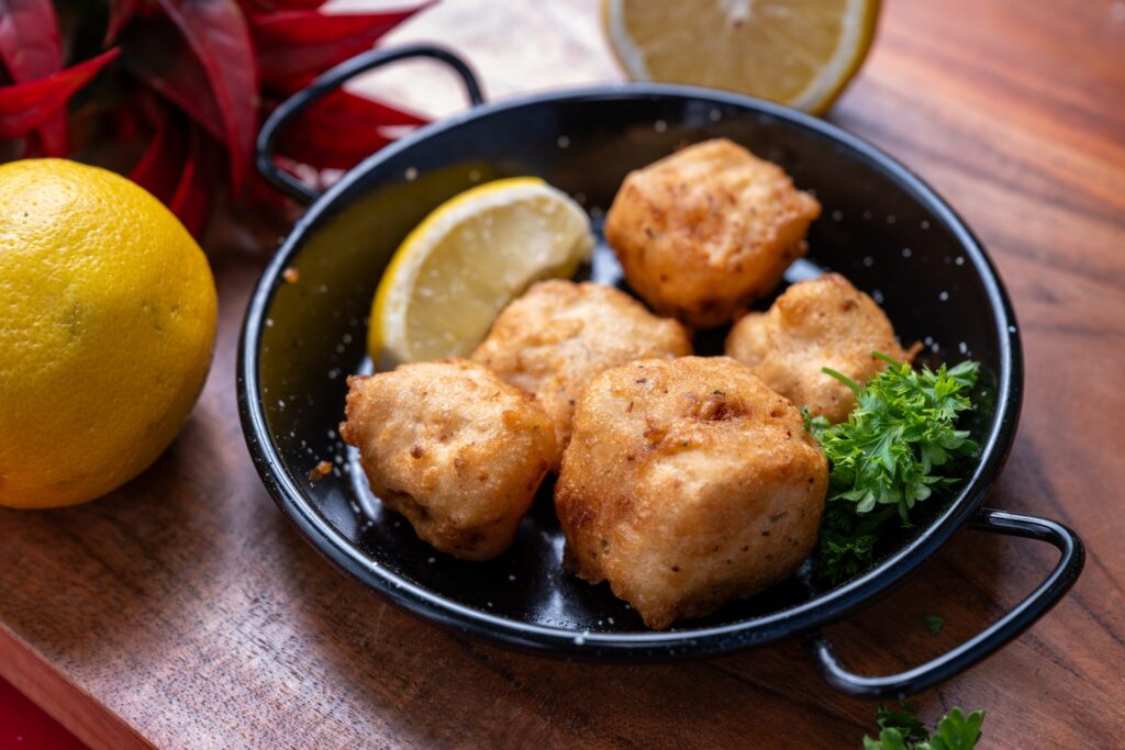 Adobo-seasoned fried fish cubes with lemon