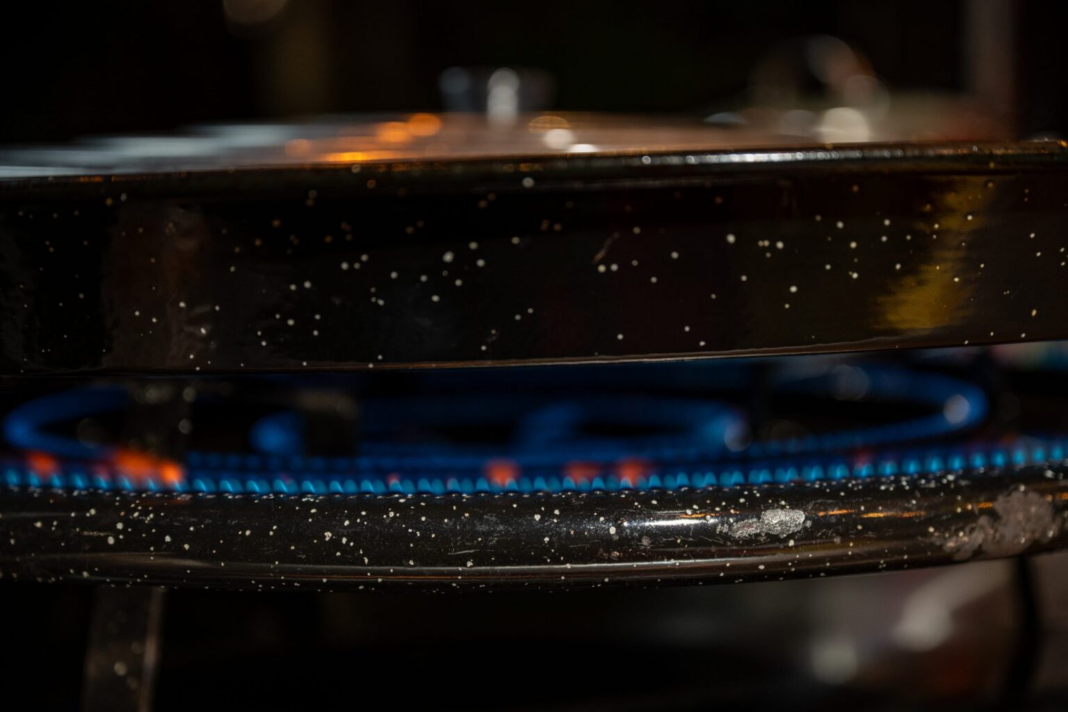 Paella pan over the blue burner flame