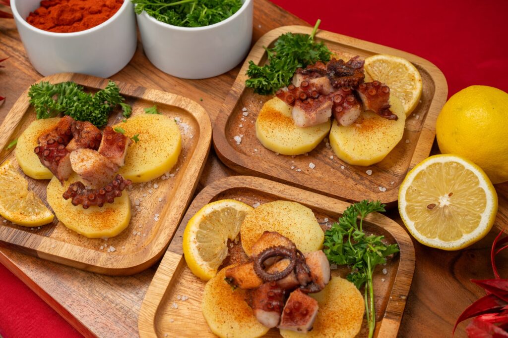 Three plates of Galician-style octopus with lemon by Nino's Tapas