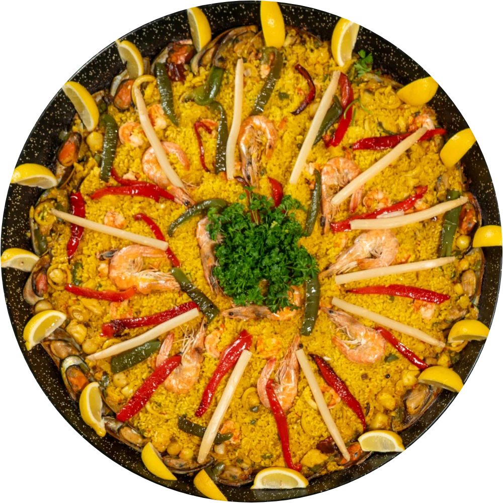 Paella de Marisco with shrimp, mussels, red peppers and lemon, overhead